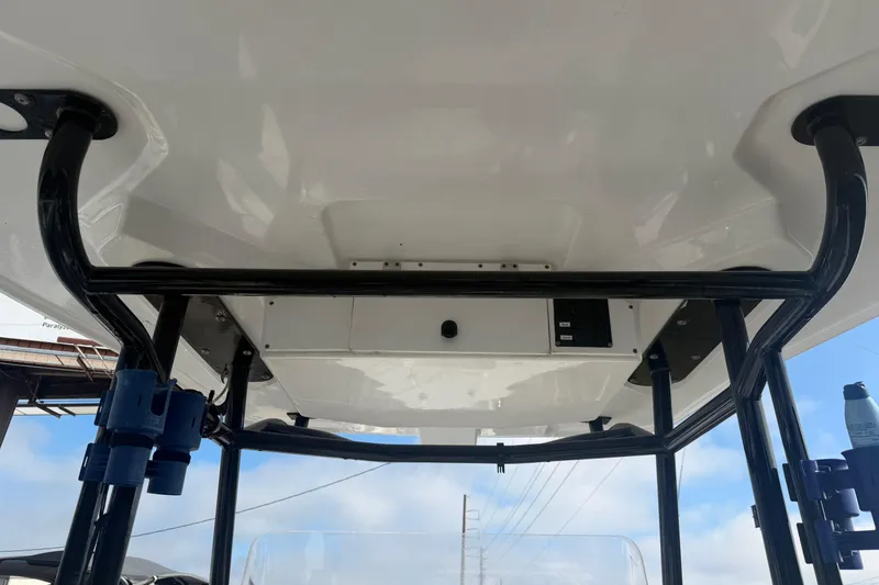 Slide: The Image of 2024 Clearwater 2800 boat T-top with sturdy black frame and clear sky background. - 12