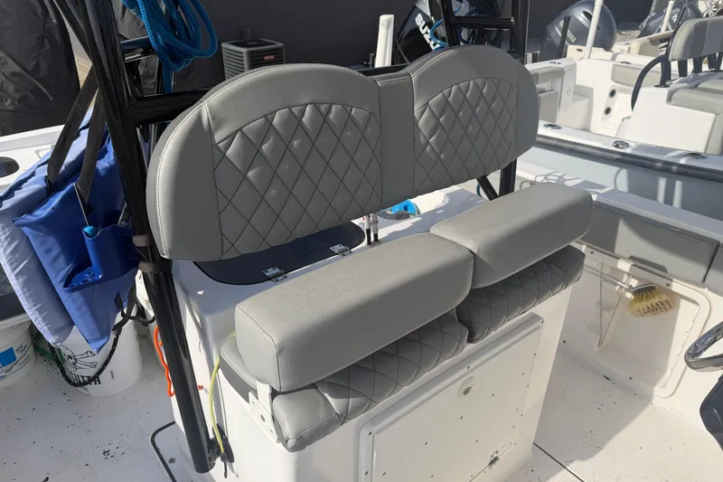 Slide: The Image of 2024 Clearwater 2800 boat with gray quilted seating and storage compartments. - 14