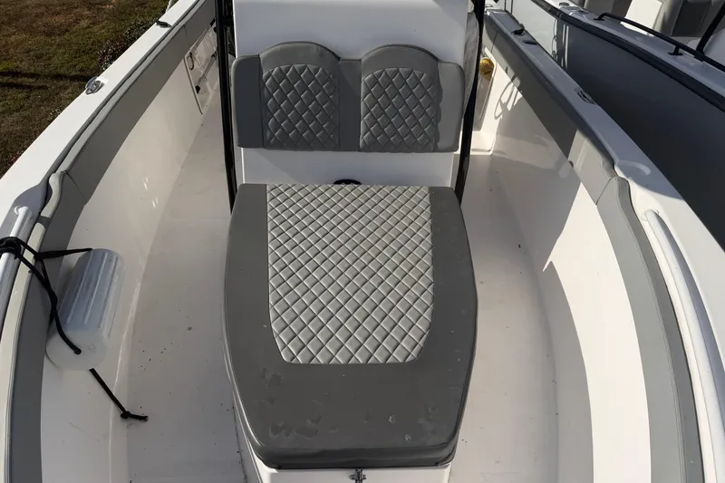 Slide: The Image of 2024 Clearwater 2800 boat interior with gray quilted seating. - 17