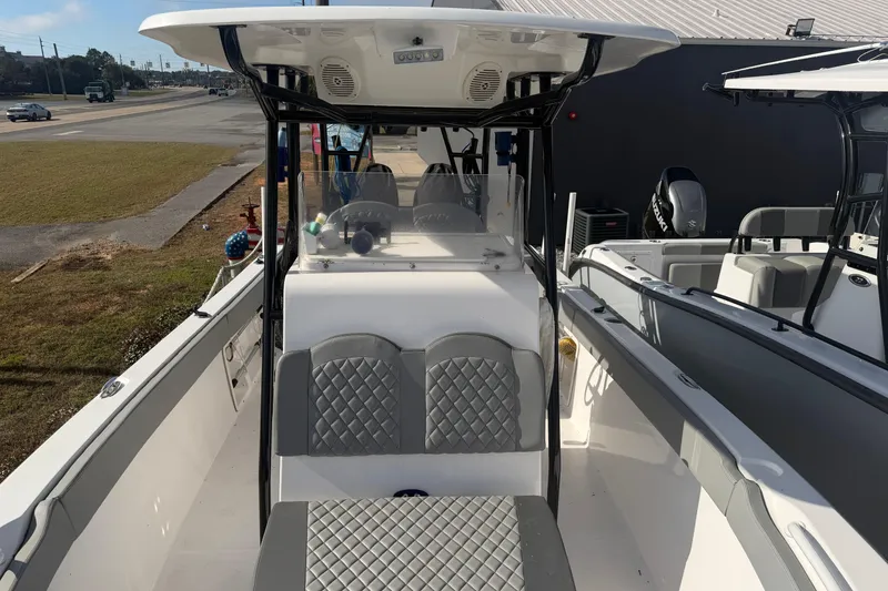 Slide: The Image of 2024 Clearwater 2800 boat interior with diamond-stitched seating and modern console design. - 18