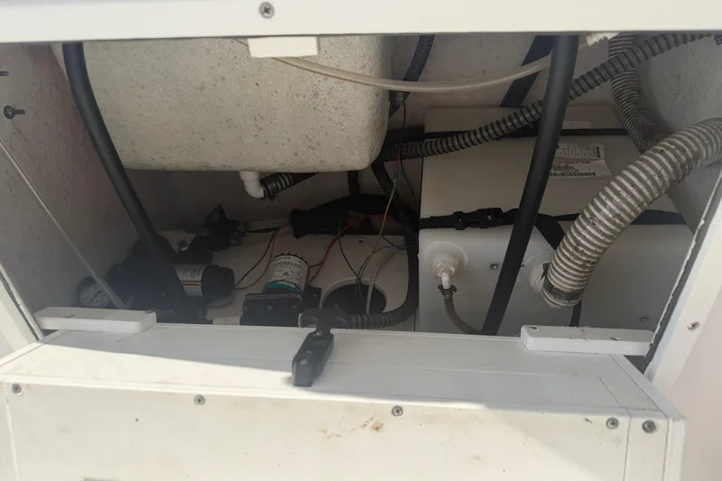 Slide: The Image of Interior view of 2024 Clearwater 2800 model's mechanical compartment with hoses and wiring. - 30