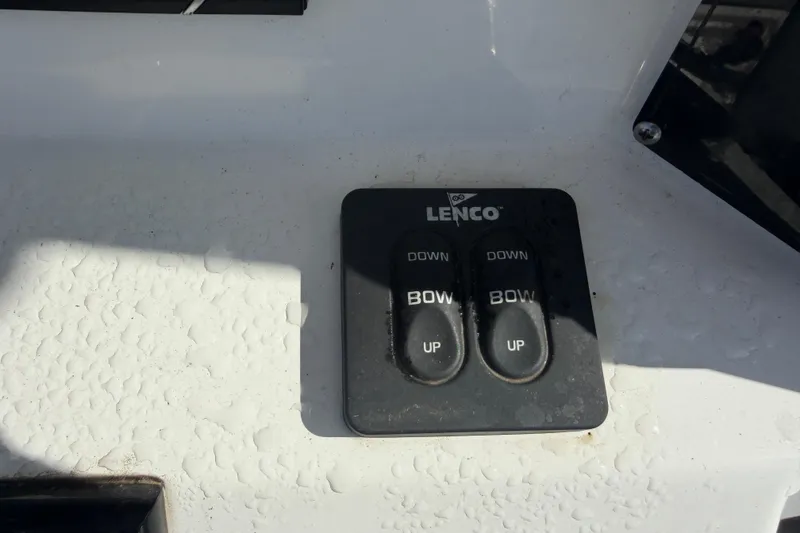 Slide: The Image of Lenco trim tab controls on 2024 Clearwater 2800 boat dashboard. - 35