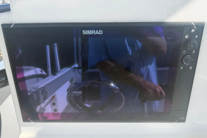 Slide: The Image of Simrad display on 2024 Clearwater 2800 boat dashboard, showing navigation controls. - 38