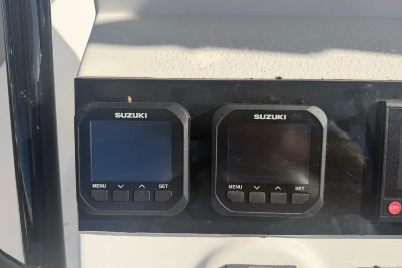 Slide: The Image of Suzuki digital displays on 2024 Clearwater 2800 boat dashboard. - 39