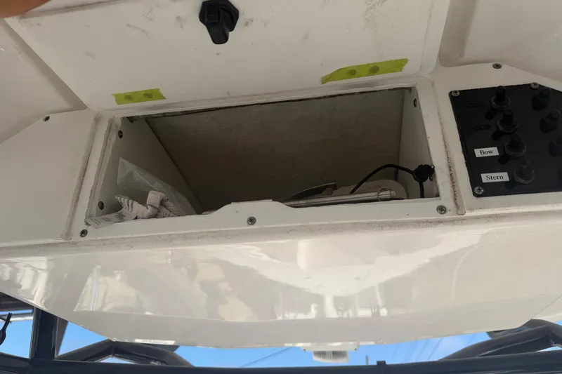 Slide: The Image of Open compartment on 2024 Clearwater 2800 boat with control panel and wiring. - 47
