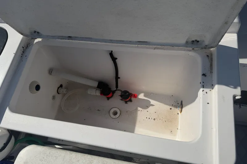 Slide: The Image of Open storage compartment in 2024 Clearwater 2800 boat, showing interior details. - 49