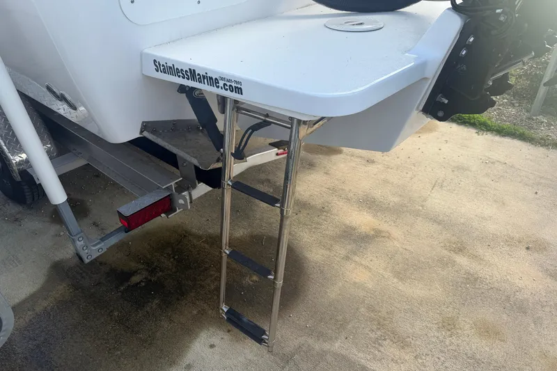 Slide: The Image of 2024 Clearwater 2800 boat with stainless steel ladder and trailer attachment. - 5
