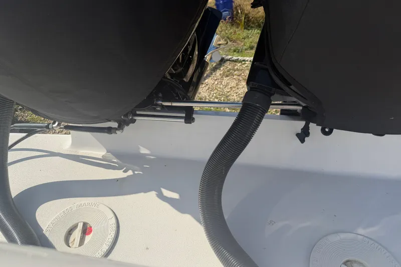 Slide: The Image of 2024 Clearwater 2800 boat engine compartment with hoses and stainless marine fittings. - 52