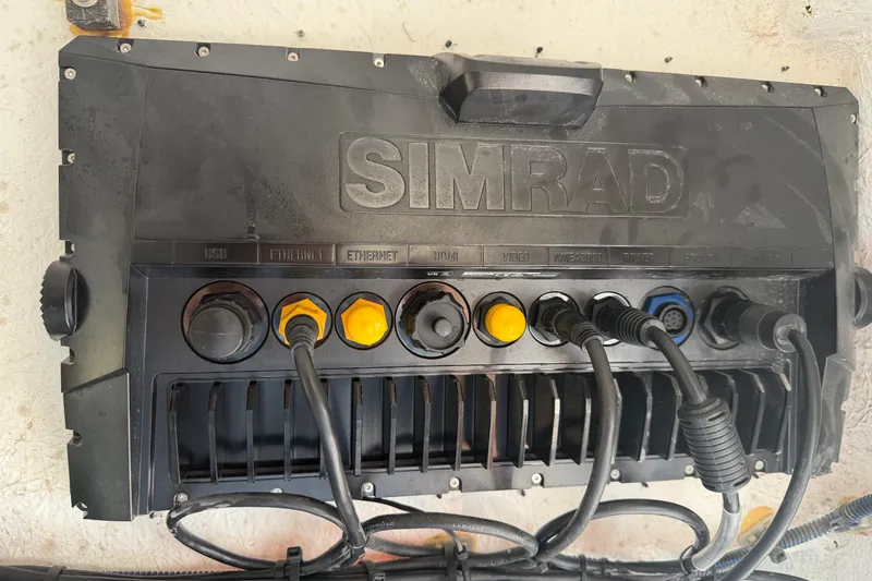 Slide: The Image of Simrad marine electronics panel with multiple connectors on Clearwater 2800, 2024 model. - 55