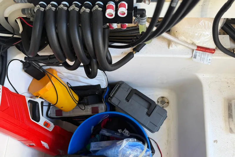 Slide: The Image of 2024 Clearwater 2800 boat storage area with tools, cables, and equipment. - 59