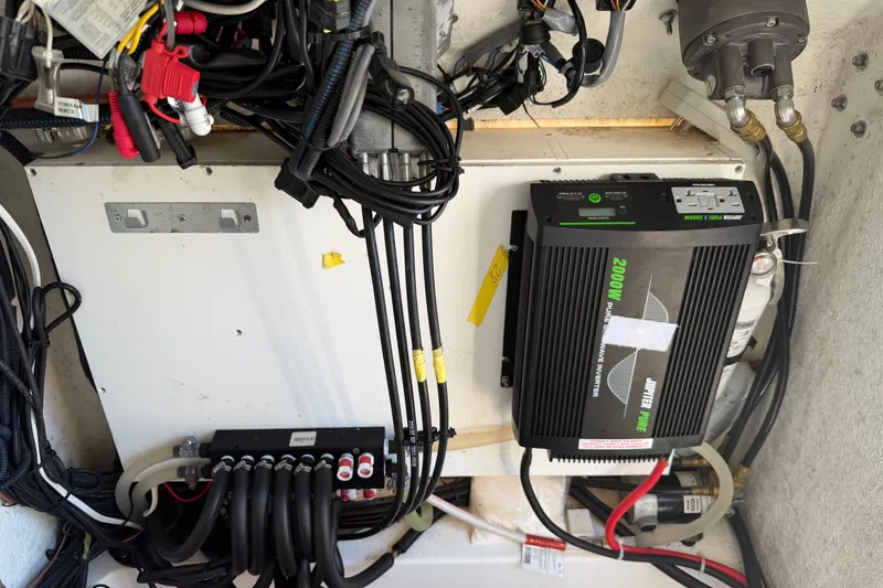 Slide: The Image of Electrical system setup in a 2024 Clearwater 2800 boat, featuring a power inverter and wiring. - 60