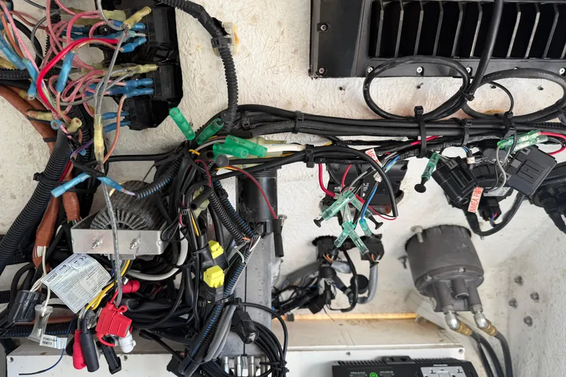 Slide: The Image of Wiring and components inside a 2024 Clearwater 2800 boat, showcasing electrical connections. - 61