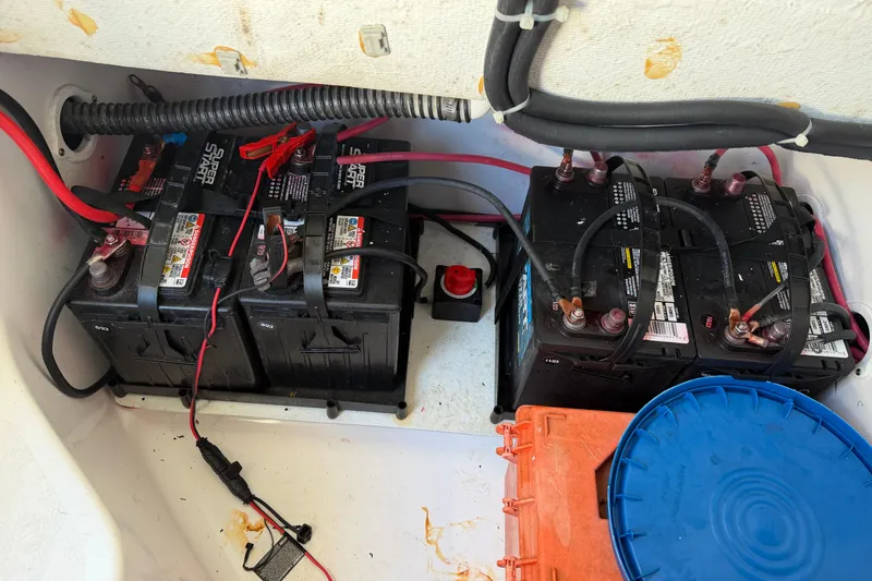 Slide: The Image of Battery compartment of 2024 Clearwater 2800 boat with wiring and connections. - 62