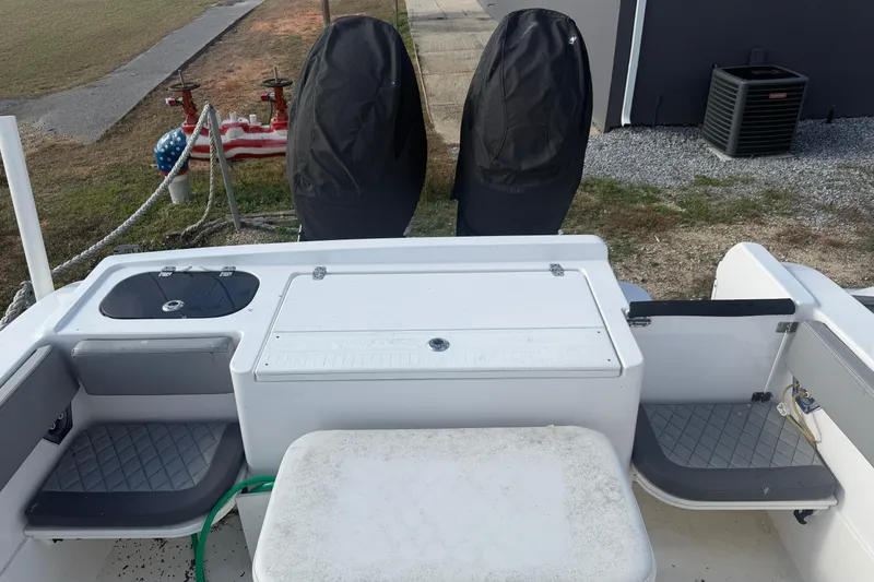 Slide: The Image of 2024 Clearwater 2800 boat deck with covered engines and seating area. - 9