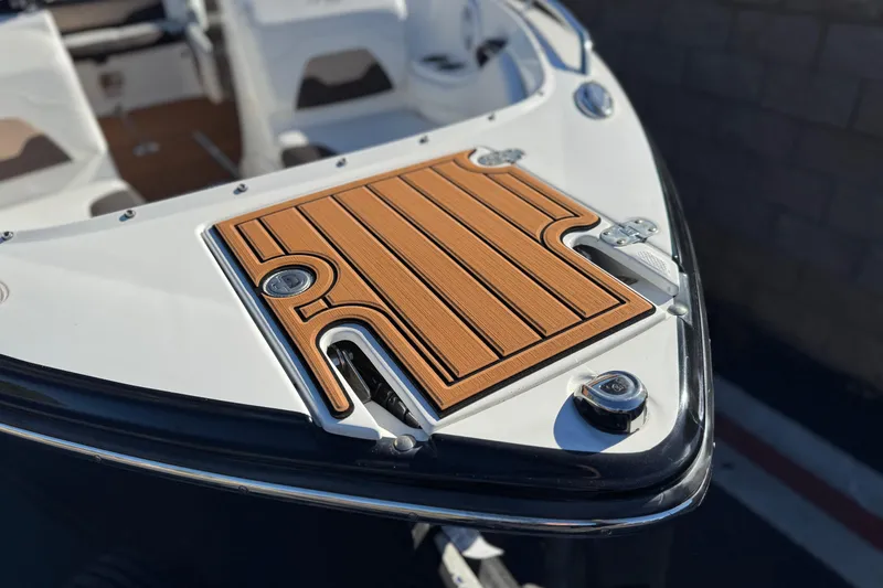 Slide: The Image of 2019 Monterey 224FS boat bow with teak-style decking and stainless steel fittings. - 11