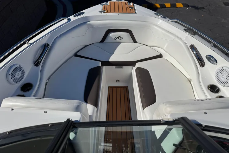 Slide: The Image of 2019 Monterey 224FS boat interior with white seating and wood accents. - 13