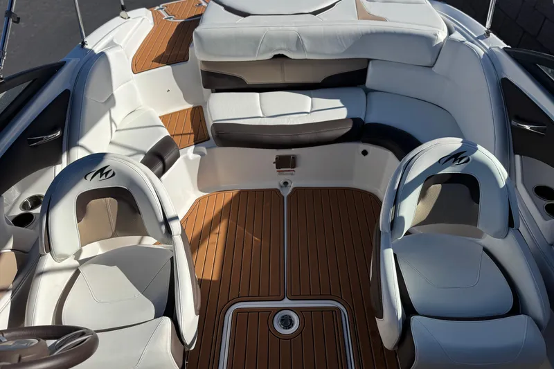 Slide: The Image of Interior of a 2019 Monterey 224FS boat with white seating and wood flooring. - 17