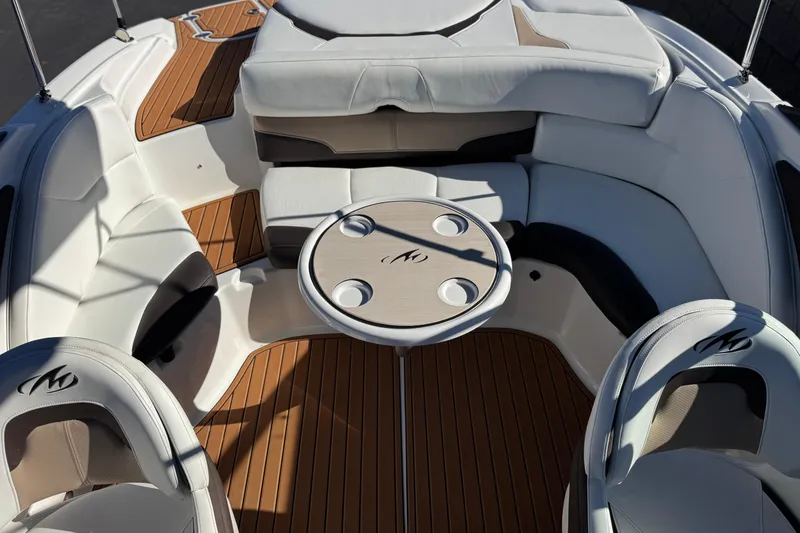 Slide: The Image of 2019 Monterey 224FS boat interior with cushioned seating and round table. - 19