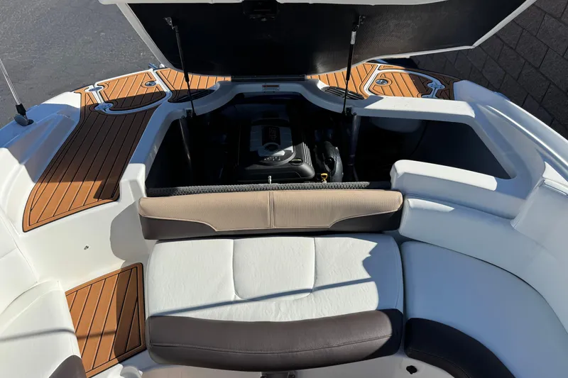 Slide: The Image of 2019 Monterey 224FS boat interior with open engine compartment and cushioned seating. - 20