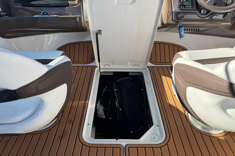 Slide: The Image of 2019 Monterey 224FS boat interior with open storage compartment and seating. - 23