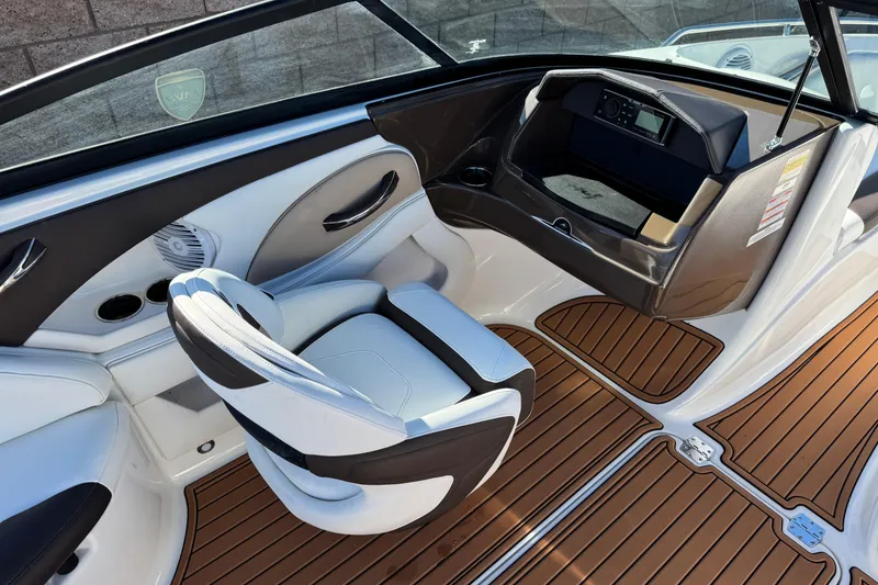 Slide: The Image of 2019 Monterey 224FS boat interior with sleek seating and wood-style flooring. - 24