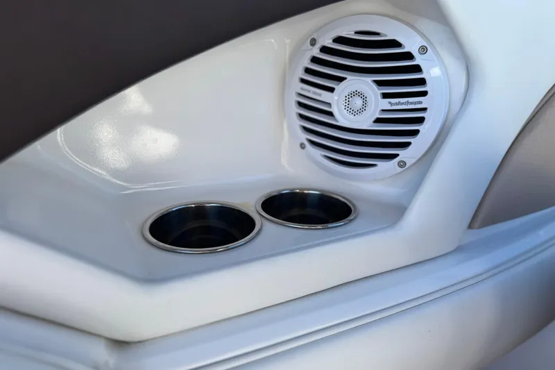 Slide: The Image of 2019 Monterey 224FS boat interior with speaker and dual cup holders. - 25