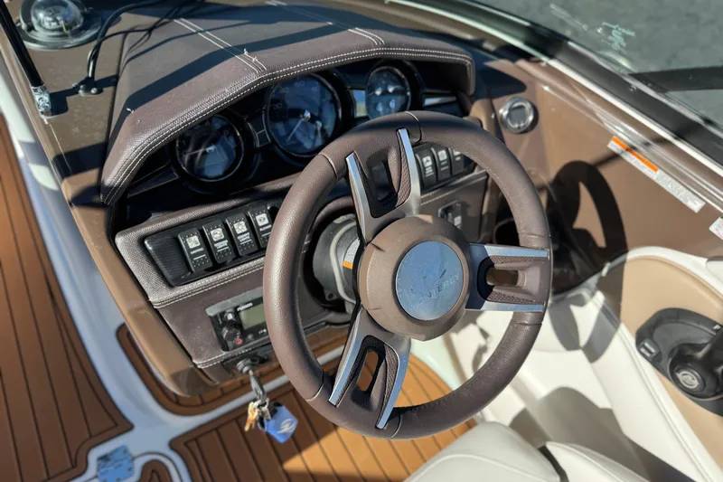 Slide: The Image of Steering wheel and dashboard of 2019 Monterey 224FS boat, featuring modern controls and gauges. - 28