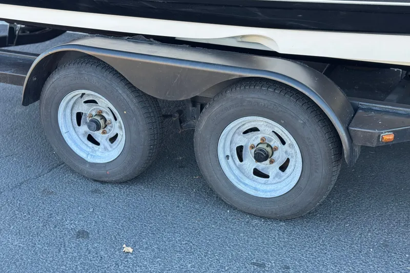 Slide: The Image of Trailer wheels of a 2019 Monterey 224FS boat on asphalt surface. - 29
