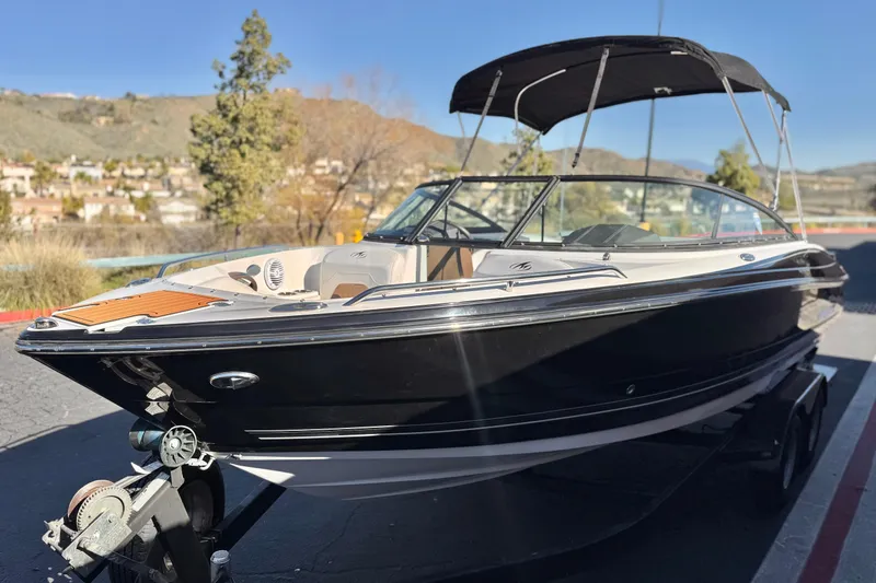Slide: The Image of 2019 Monterey 224FS boat on trailer, black exterior, parked outdoors. - 3