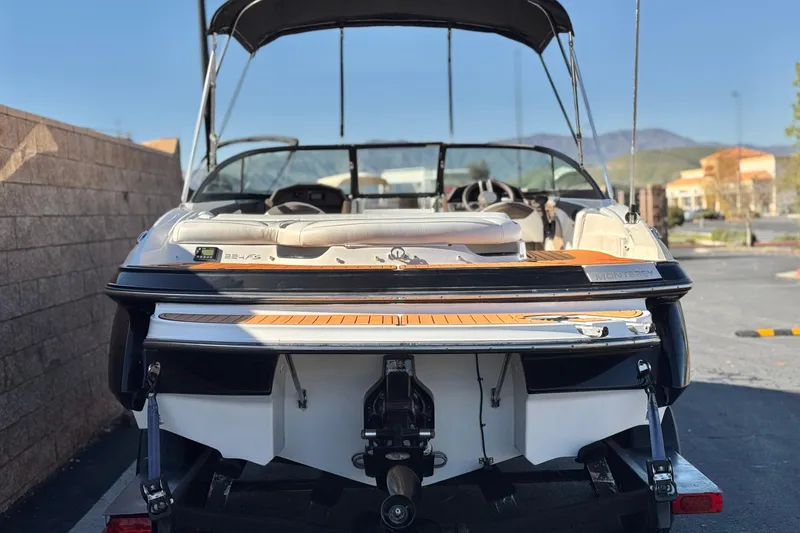 Slide: The Image of 2019 Monterey 224FS boat on trailer, rear view, parked outdoors. - 4