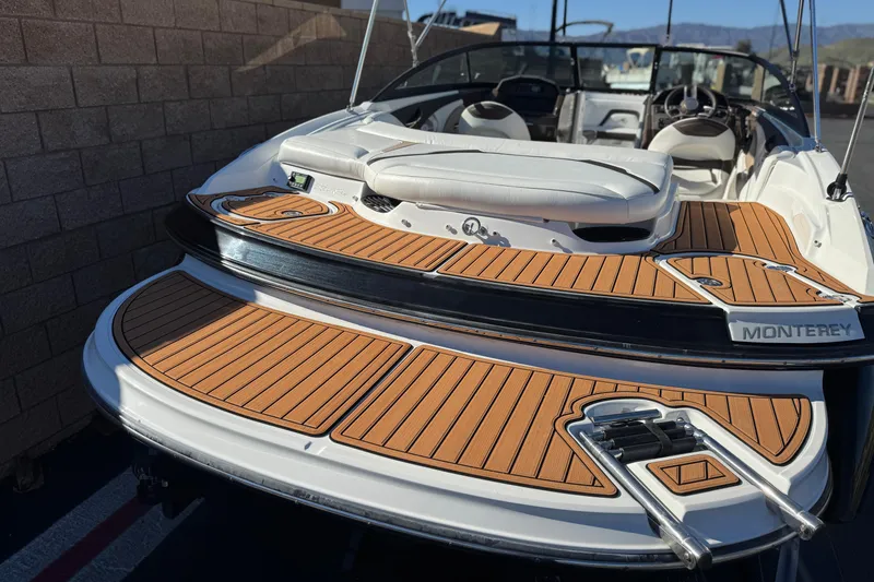 Slide: The Image of 2019 Monterey 224FS boat with teak deck, sleek design, and comfortable seating. - 6