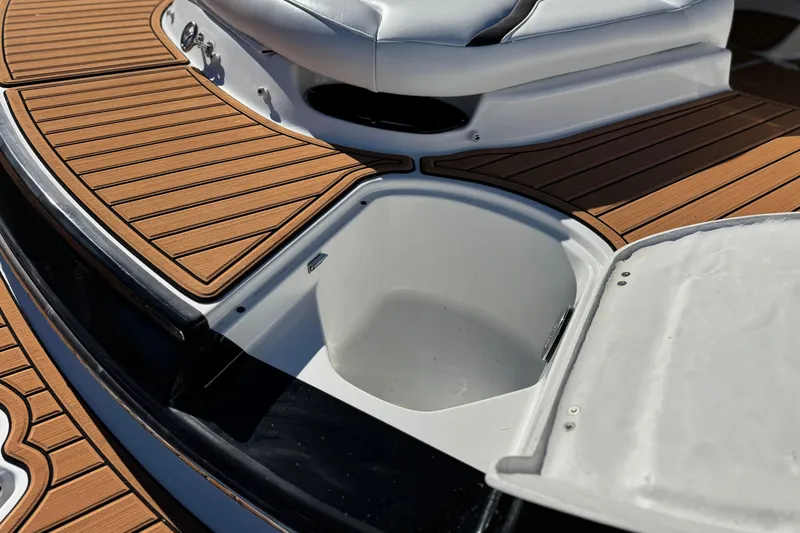 Slide: The Image of 2019 Monterey 224FS boat with open storage compartment on teak deck. - 7
