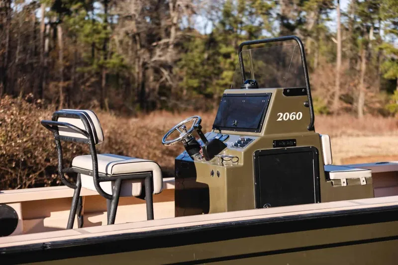 Slide: The Image of Bay Rider 2060 boat console and seating, 2015 model, in a natural setting. - 12