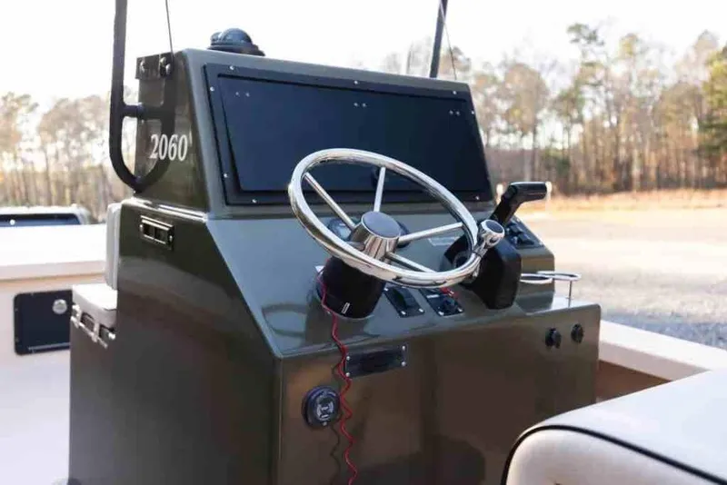 Slide: The Image of 2015 Bay Rider 2060 boat console with steering wheel and controls. - 16