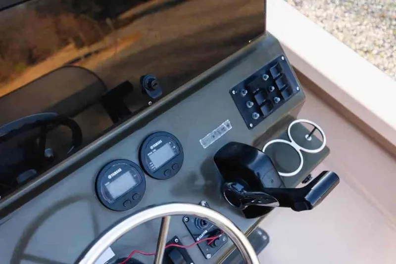 Slide: The Image of Control panel of 2015 Bay Rider 2060 boat with gauges and steering wheel. - 19