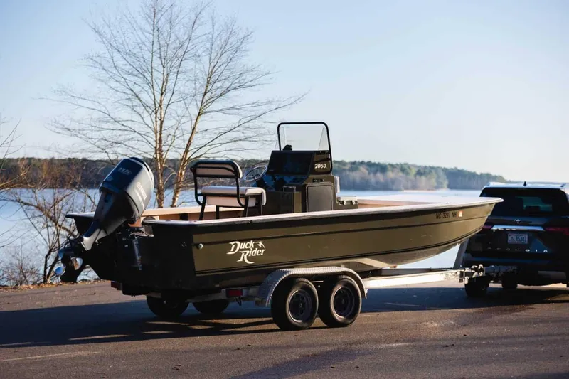 Slide: The Image of 2015 Bay Rider 2060 boat on trailer by a lake, ready for launch. - 2