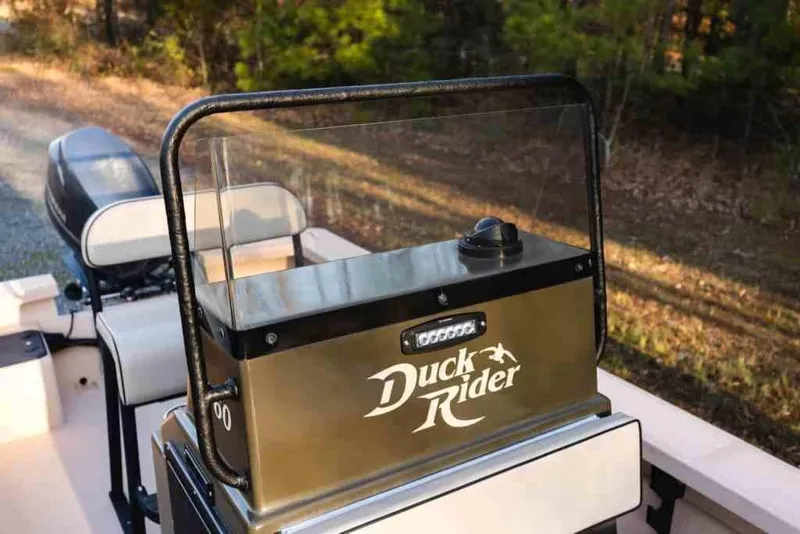 Slide: The Image of 2015 Bay Rider 2060 boat console with "Duck Rider" branding, outdoor setting. - 24