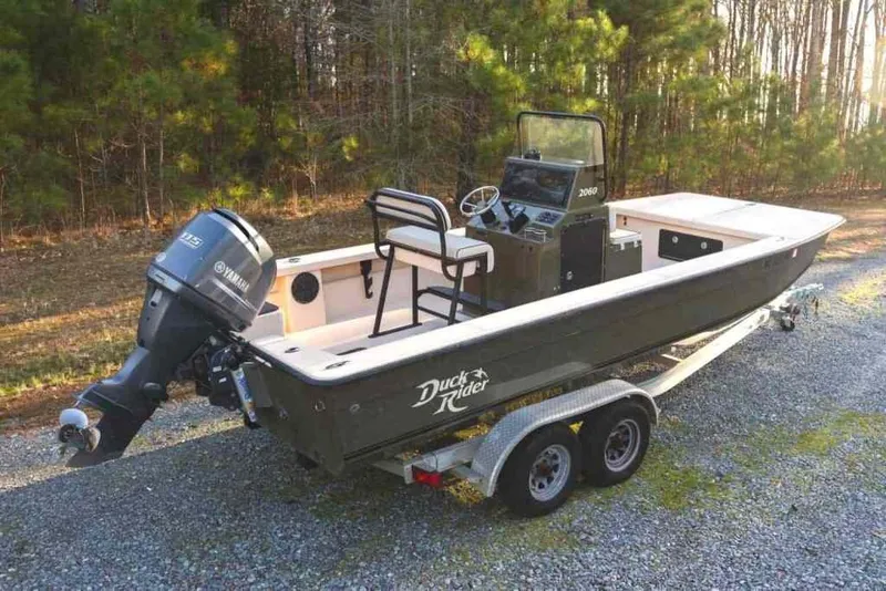 Slide: The Image of 2015 Bay Rider 2060 boat with Yamaha motor on trailer, parked outdoors. - 5