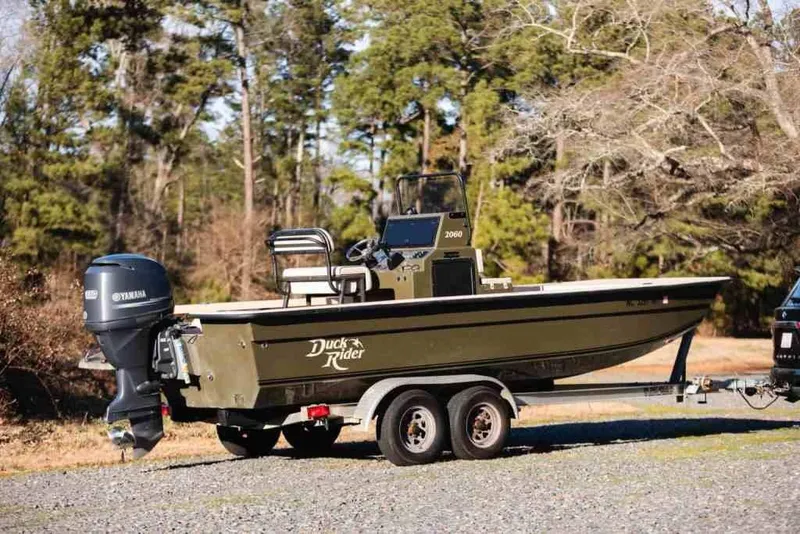 Slide: The Image of 2015 Bay Rider 2060 boat on trailer with Yamaha motor, parked outdoors. - 6