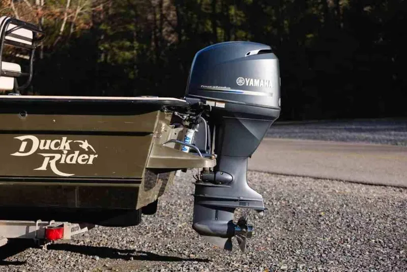 Slide: The Image of Bay Rider 2060 boat with Yamaha outboard motor, 2015 model, parked on gravel. - 8