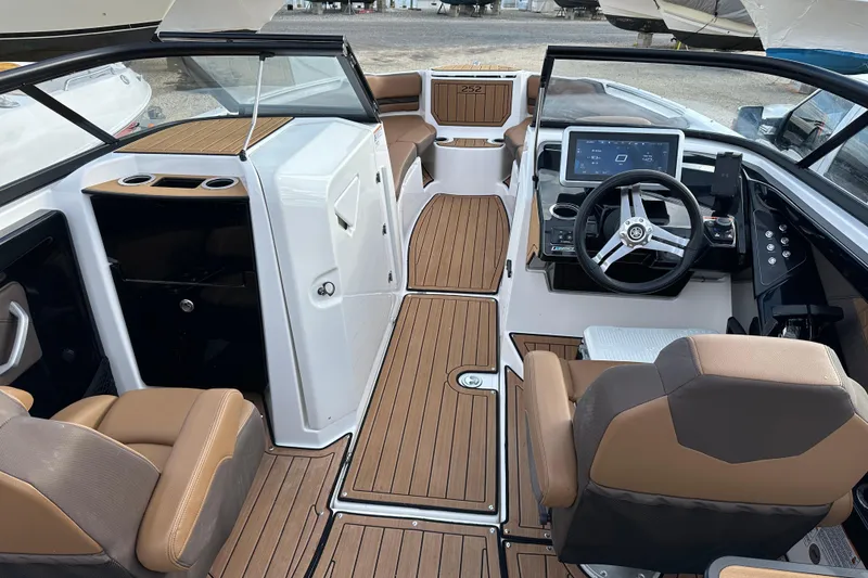 Slide: The Image of 2024 Yamaha Boats 252SE interior with modern dashboard and seating. - 12