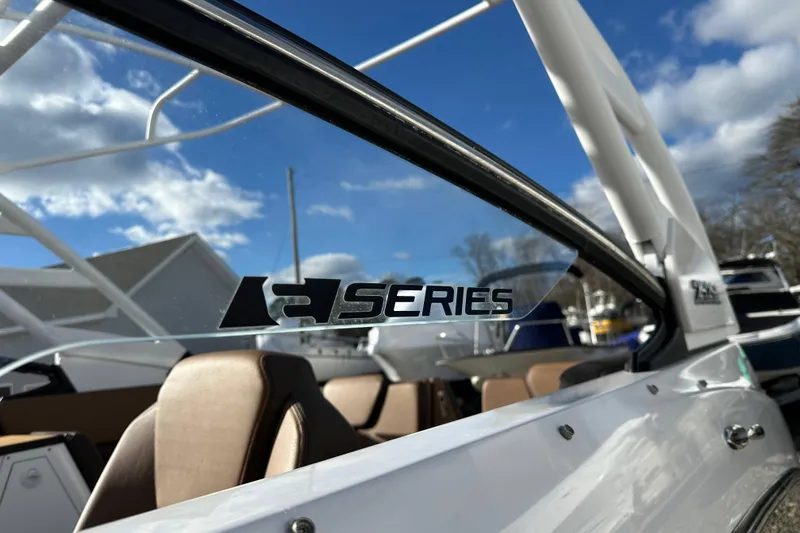 Slide: The Image of 2024 Yamaha Boats 252SE, close-up of R Series logo on sleek design. - 15