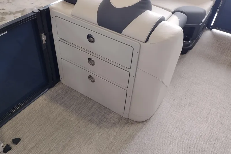 Slide: The Image of Open storage compartment in 2026 Tahoe Pontoon 23 LTZ Rear Bench boat. - 103