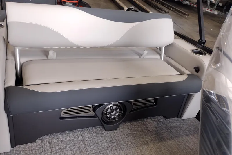 Slide: The Image of 2026 Tahoe Pontoon 23 LTZ Rear Bench storage compartment with open lid and latch. - 107