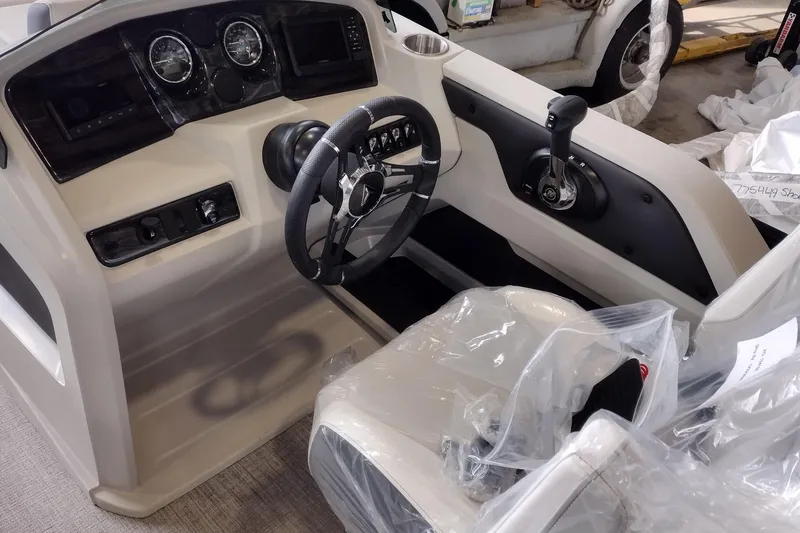 Slide: The Image of 2026 Tahoe Pontoon 23 LTZ Rear Bench dashboard with illuminated controls and steering wheel. - 110