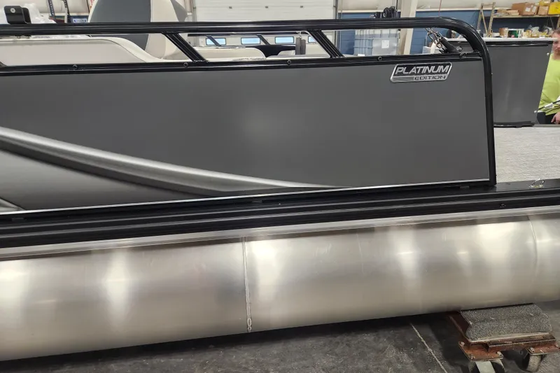 Slide: The Image of 2026 Tahoe Pontoon 23 LTZ Rear Bench, Platinum Edition, side view in a showroom. - 117