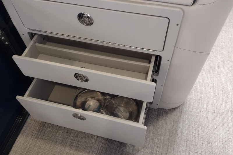 Slide: The Image of Open storage drawers in 2026 Tahoe Pontoon 25E85 LTZ Rear Bench, showcasing interior design. - 144