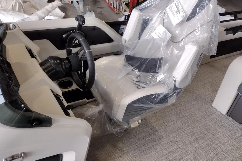 Slide: The Image of 2026 Tahoe Pontoon 25E85 LTZ Rear Bench captain's chair wrapped in protective plastic. - 145