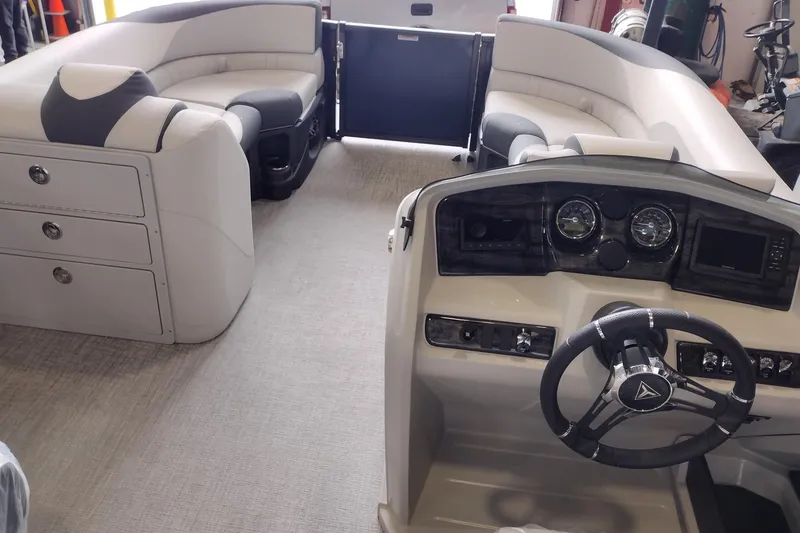 Slide: The Image of Interior of 2026 Tahoe Pontoon 25E85 LTZ Rear Bench with modern dashboard and seating. - 149