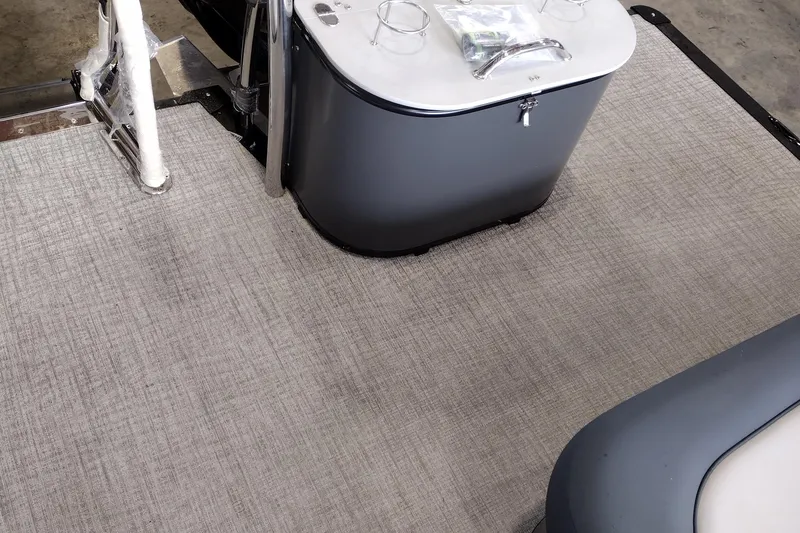 Slide: The Image of 2026 Tahoe Pontoon 25E85 LTZ Rear Bench interior with gray flooring and storage compartments. - 151